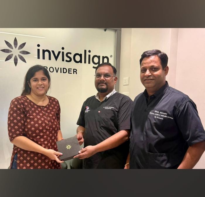 Patient receiving Invisalign box at Shree Sadguru Dental Clinic