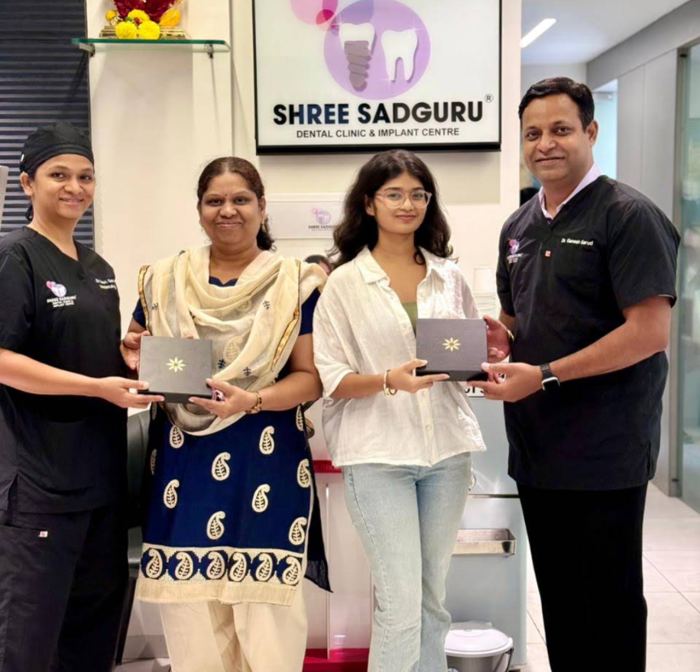 Patients and family with Shree Sadguru Dental Clinic team